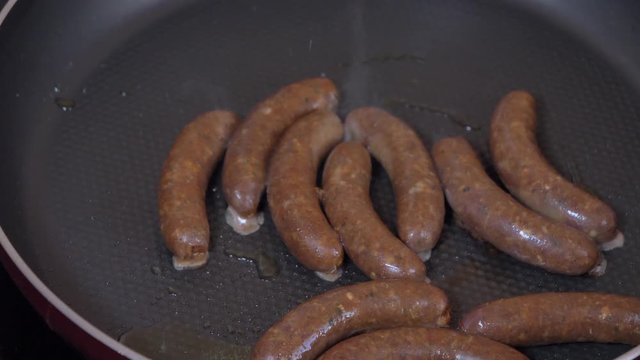 Close up shot of sausages and on the grill