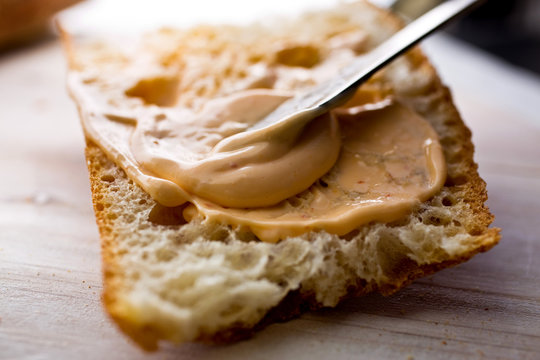 Close up of homemade†sriracha†mayo being spread on bread