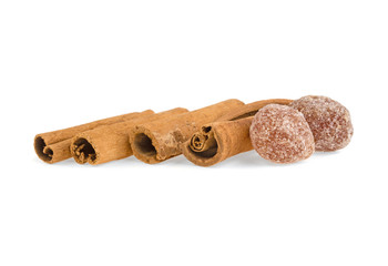 candied fruits and cinnamon sticks on a white background isolated