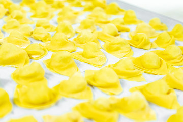 Tortellini, homemade cappelletti. Working in the kitchen and making fresh homemade pasta.