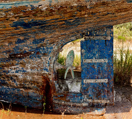 old, rusty ship abandoned on the shore.