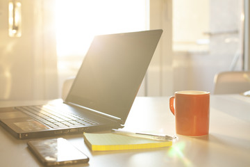 Smartworking set to work in quarantine from home with laptop, mobile and block notes
