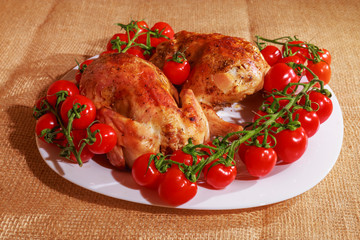 Fried chicken and tomatoes are on a plate. Home cooking.