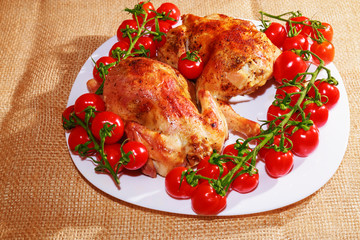 Fried chicken and tomatoes are on a plate. Home cooking.
