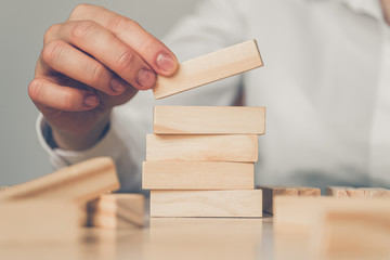 Successful business concept - hand holds wooden blocks.