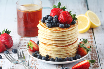 A stack if home-made pancakes with berry