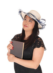 Chinese woman in a dress and hat holding her book