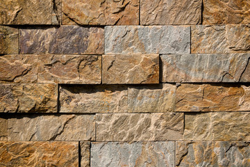 Brown brick wall made of stone blocks.