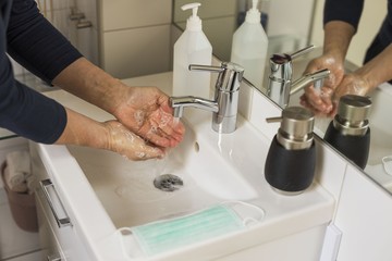 Close up view of male washing and sanitizing hands. COVID 19. Health concept. 