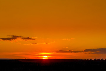 Sunset in the field, picturesque evening sky in red