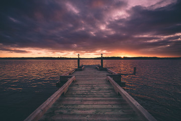 Obraz na płótnie Canvas The pier during the beautiful sunset in the horizon in Nova Scotia Canada