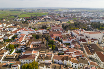 Fototapeta na wymiar Evora drone aerial view on a sunny day with historic buildings city center and church in Alentejo, Portugal