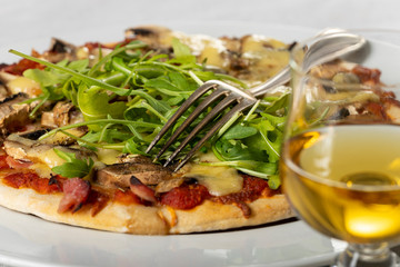 pizza on a plate with arugula