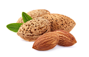 Almonds with leaves in closeup isolated on white background.