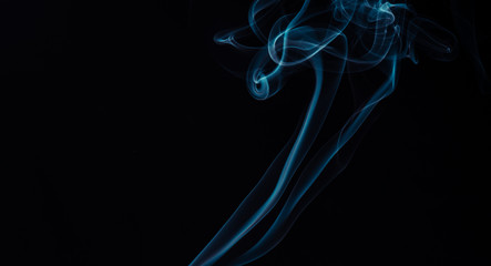 Blue smoke on black background