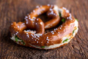 bavarian pretzel with butter on wood