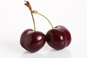 Two cherries isolated on a white background