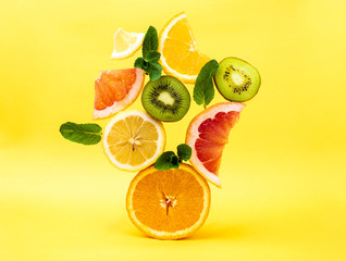Citrus fruits ,orange, lemon, grapefruit, tangerine, lime on a yellow background