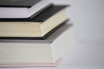 Three stacked books on white background
