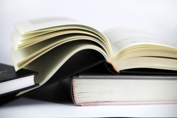 Three stacked books on white background