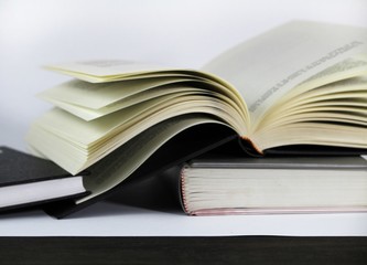 Three stacked books on white background