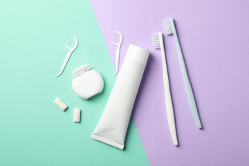 Tools for dental care on two tone background, top view