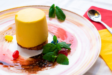Passion fruit mango cake on a decorated white plate