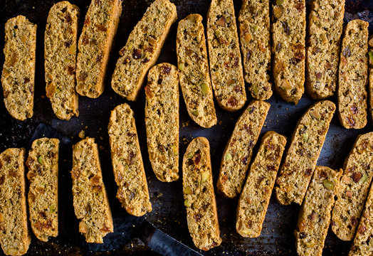 Overhead view of gluten free raisin pistachio biscotti on baking sheet