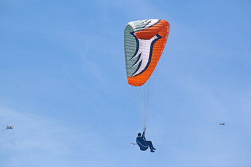 Paraglider flying wing in a blue sky	