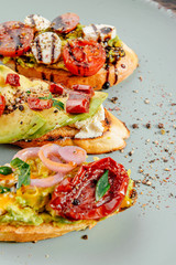 bruschettas with avocado tomatoes mozzarella sun-dried tomatoes and spices