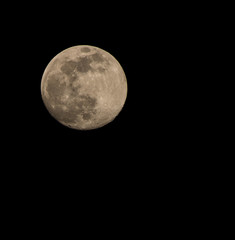 Natural full moon close up with dark sky background