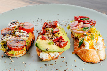 bruschettas with avocado tomatoes mozzarella sun-dried tomatoes and spices