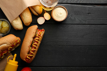 Composition with tasty hot dogs on wooden background