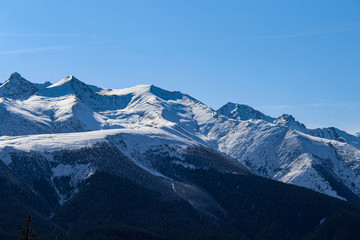 Fototapeta na wymiar Snow-capped mountain peaks