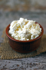 Fresh homemade cottage cheese in a bowl. Grain curd.