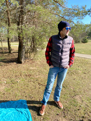 Man in sunglasses in city park enjoying in springtime
