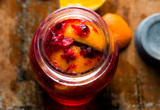 Close up of cranberry cordial in jar