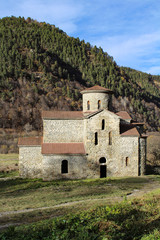 Fototapeta premium Ancient stone temple on a hill in Arkhyz