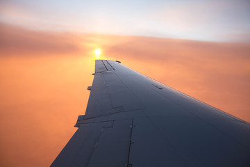 cloudy sunset sky over plane wing