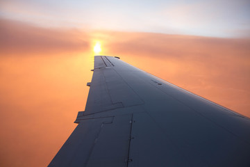 cloudy sunset sky over plane wing