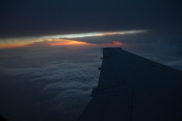 cloudy sunset sky over plane wing