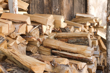 Wooden chopped firewood stacked on top of each other