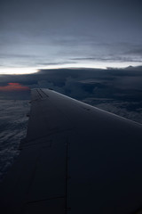 cloudy sunset sky over plane wing