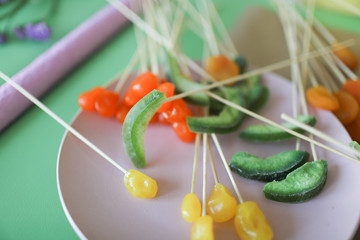 The process of preparing a handmade fruit bouquet.