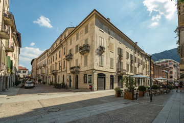 Fototapeta na wymiar Como, ITALY - August 4, 2019: Local people and tourists on a quiet cozy streets in the center of beautiful Italian Como city. Warm sunny summer day in very popular holiday destination