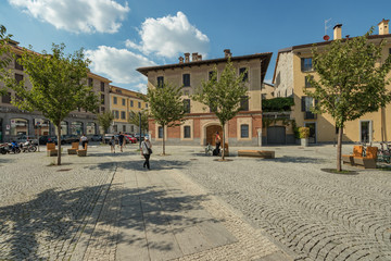 Como, ITALY - August 4, 2019: Local people and tourists on a quiet cozy streets in the center of beautiful Italian Como city. Warm sunny summer day in very popular holiday destination