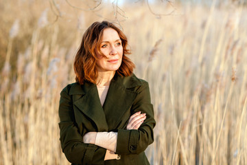 portrait of middle aged woman posing at the park