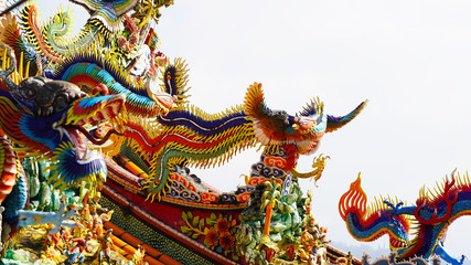 Fototapeta na wymiar bright multi-colored sculptures of Japanese samurai dragons on the roof of traditional temples. religion in asia. a religious temple rises above a Chinese city. korean chinese japanese temples