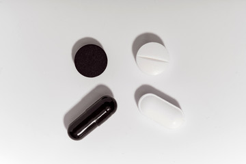 White and black pills isolated on white background.