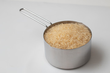 Parbolizado Rice into a measuring cup. Parboiled Type
